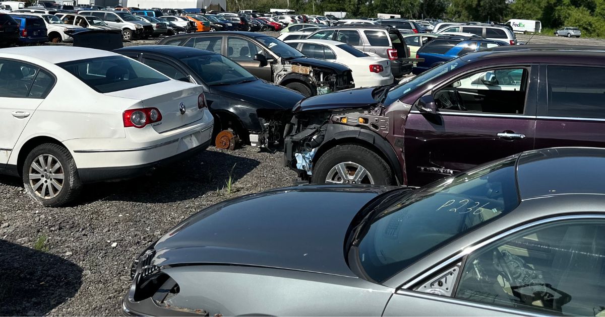 Stacked scrap cars awaiting recycling at a Toronto facility.