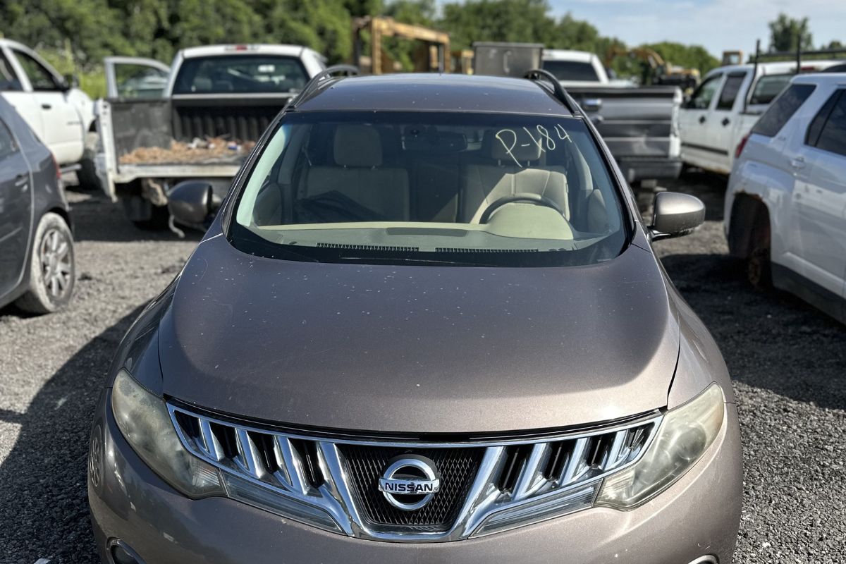 An old Nissan car with pass number 184 parked at Greenway Scrapyard, ready for scrapping your car and recycling valuable parts.