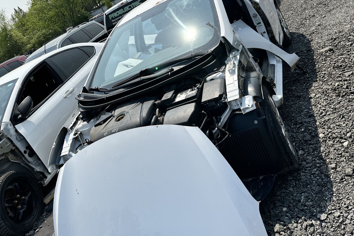 Smart Scrapping white car with open hood, ready to get scrapped